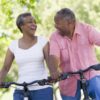 older man and woman riding bikes and laughing